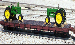 flatcar with 2 tractors